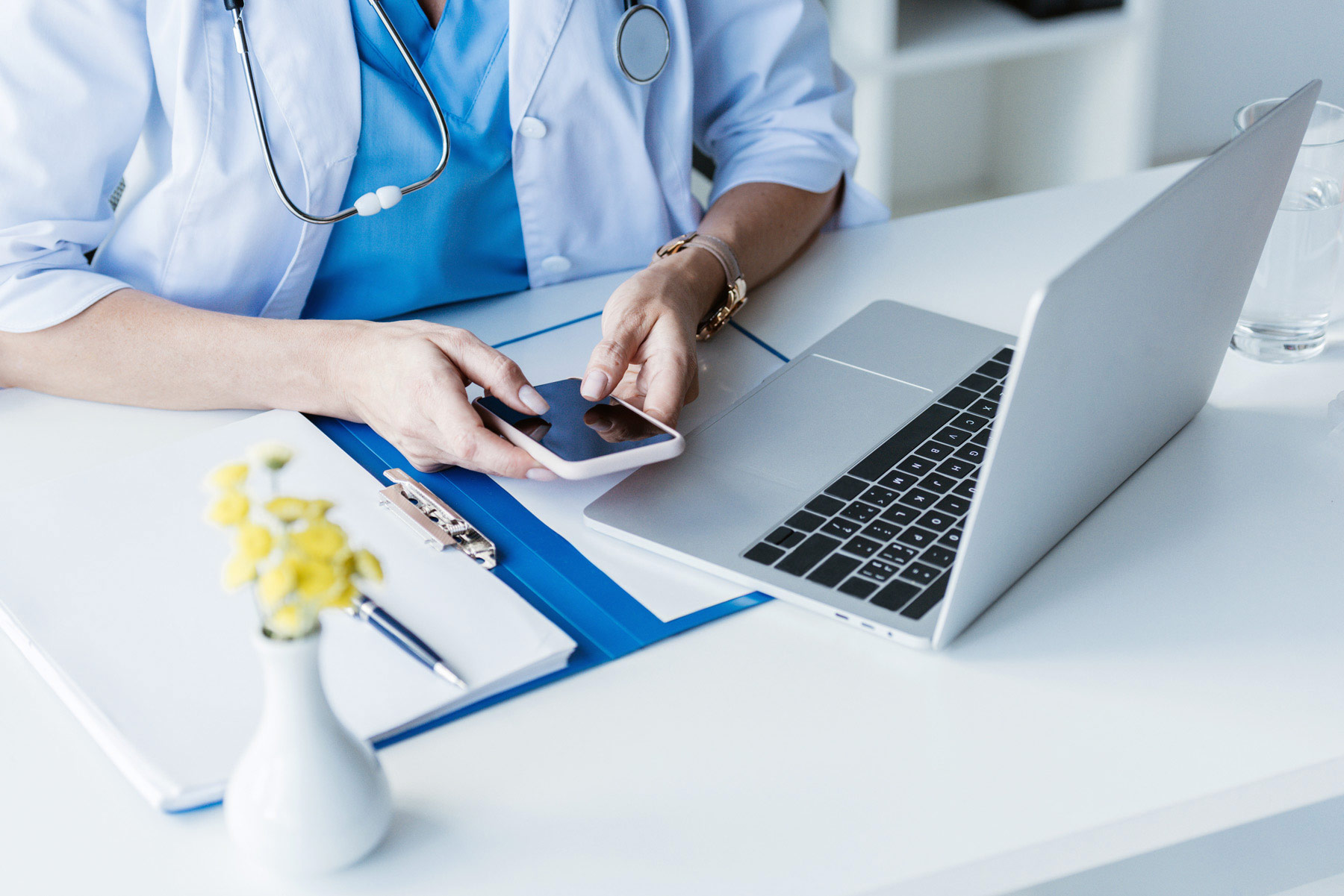 Clinician using MatchMD on phone and laptop